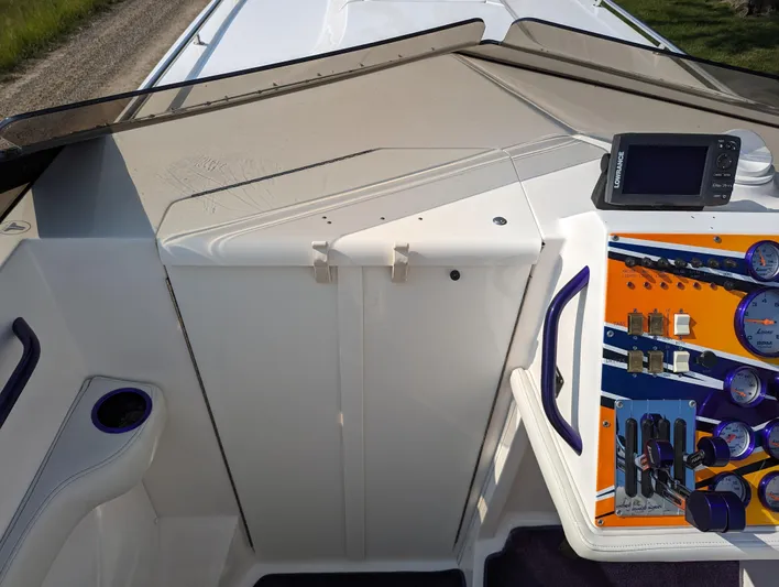  Yacht Photos Pics Cockpit of a 2006 Fountain 42 boat with control panel and navigation equipment.