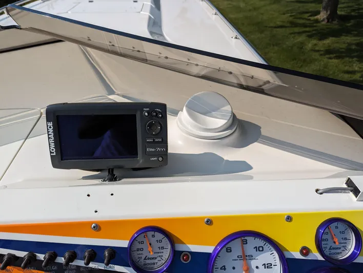  Yacht Photos Pics Dashboard of a 2006 Fountain 42 boat with gauges and a Lowrance device.