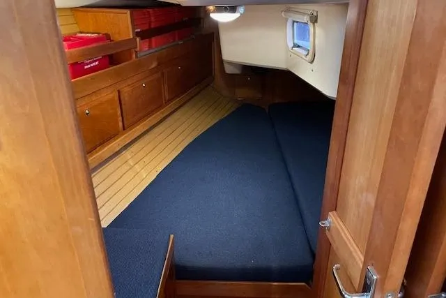 Souwester Yacht Photos Pics 2003 Sabre 362 yacht interior cabin with wooden finish and blue bedding.