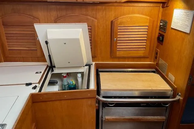 Souwester Yacht Photos Pics 2003 Sabre 362 yacht galley with wooden cabinetry, storage compartments, and built-in appliances.