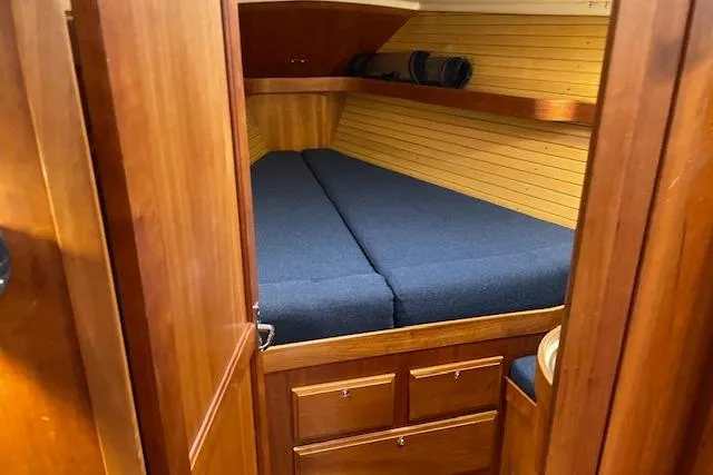 Souwester Yacht Photos Pics 2003 Sabre 362 yacht cabin with wooden interior and blue bedding.