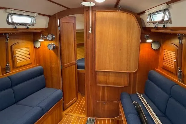 Souwester Yacht Photos Pics Interior of 2003 Sabre 362 sailboat with wooden paneling and blue seating.