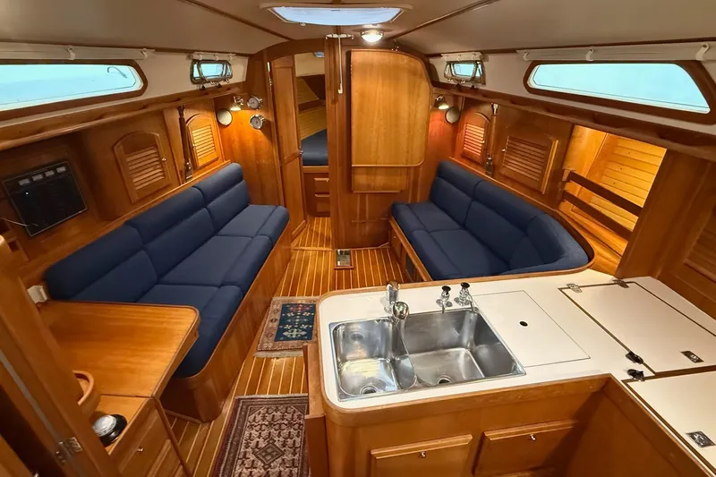 Souwester Yacht Photos Pics Luxurious interior of 2003 Sabre 362 yacht with blue seating and wooden finishes.