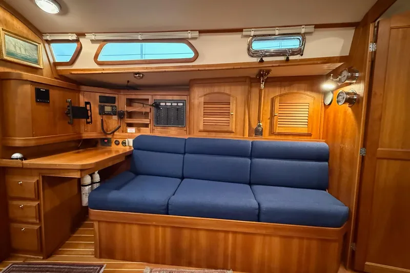 Souwester Yacht Photos Pics Interior of 2003 Sabre 362 yacht with blue cushioned seating and wooden cabinetry.