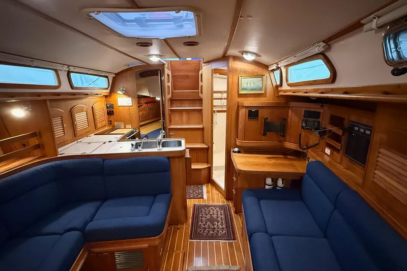 Souwester Yacht Photos Pics Interior of 2003 Sabre 362 sailboat with wooden finish and blue seating.