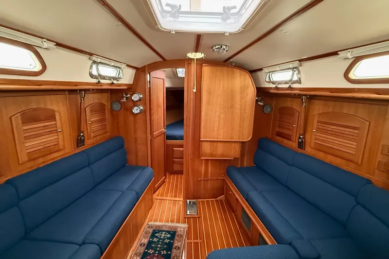 Souwester Yacht Photos Pics Interior of 2003 Sabre 362 sailboat with wooden finish and blue seating.