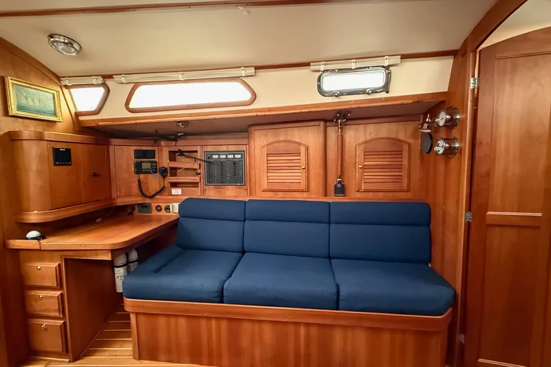 Souwester Yacht Photos Pics Interior of 2003 Sabre 362 sailboat with blue cushioned seating and wooden cabinetry.