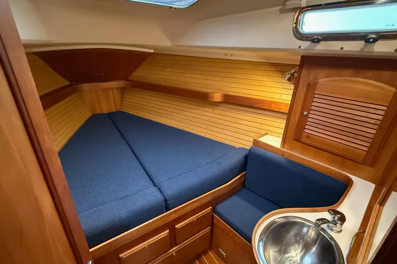 Souwester Yacht Photos Pics Cozy cabin interior of 2003 Sabre 362 sailboat with blue cushions and wooden finish.