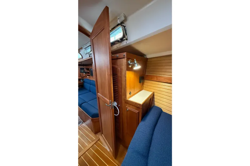Souwester Yacht Photos Pics Interior of 2003 Sabre 362 sailboat with wooden cabinetry and blue seating.