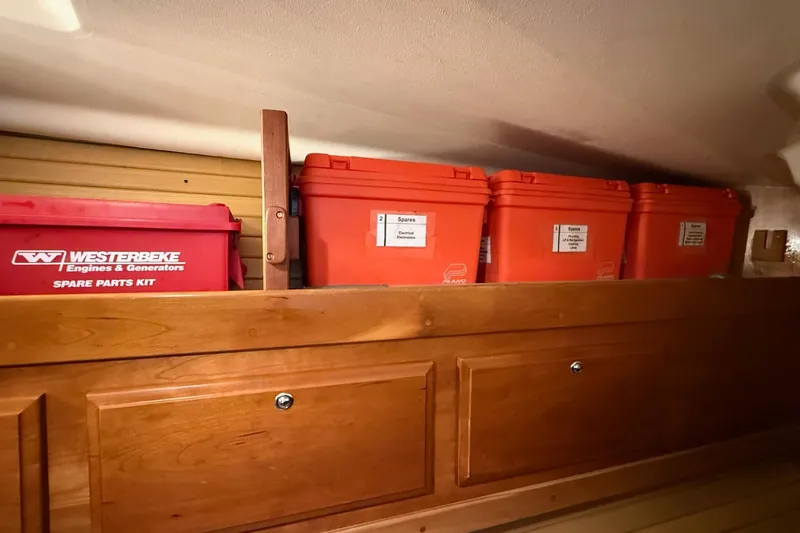 Souwester Yacht Photos Pics Storage area with labeled orange containers and a red spare parts kit on a Sabre 362, 2003 model.