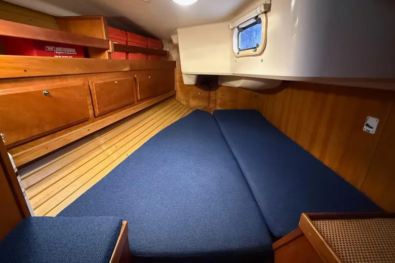 Souwester Yacht Photos Pics Cozy cabin interior of 2003 Sabre 362 sailboat with wooden cabinetry and blue cushions.