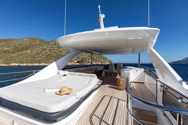  Yacht Photos Pics Luxurious 2024 Princess Y80 yacht deck with sunbed, ocean view, and clear blue sky.
