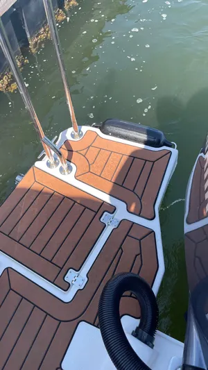  Yacht Photos Pics 2022 Ranger Tugs R-25 swim platform with teak-style decking on water.