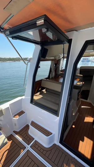  Yacht Photos Pics 2022 Ranger Tugs R-25 boat interior with open door and wooden flooring.