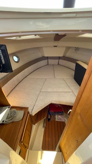  Yacht Photos Pics Interior cabin of 2022 Ranger Tugs R-25 boat with cozy seating and wooden accents.