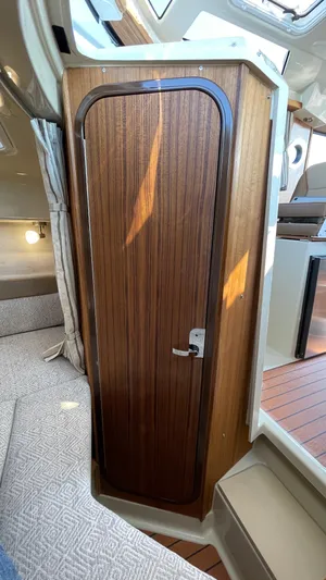  Yacht Photos Pics 2022 Ranger Tugs R-25 interior with wooden door and cozy seating area.