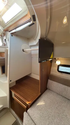  Yacht Photos Pics 2022 Ranger Tugs R-25 interior with wood accents and a mounted TV.