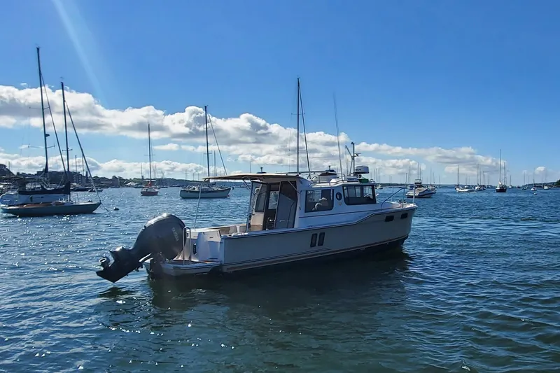 Tusen Takk Yacht Photos Pics 2024 Ranger Tugs R-27 boat on a sunny day in a marina.
