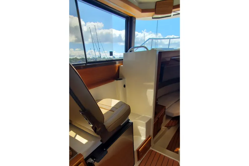 Tusen Takk Yacht Photos Pics 2024 Ranger Tugs R-27 interior with helm seat and cabin view.