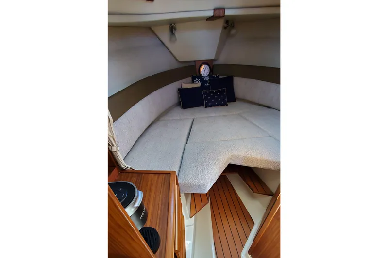 Tusen Takk Yacht Photos Pics 2024 Ranger Tugs R-27 cabin interior with cozy seating and nautical decor.