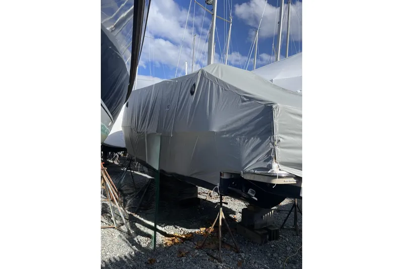 Tusen Takk Yacht Photos Pics 2024 Ranger Tugs R-27 boat covered in protective tarp, stored outdoors.