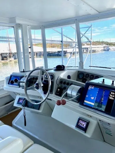  Yacht Photos Pics 1999 Carver 456 Aft Cabin Motor Yacht helm with modern navigation equipment and waterfront view.