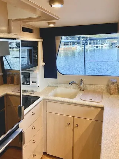  Yacht Photos Pics 1999 Carver 456 Aft Cabin Motor Yacht kitchen with modern appliances and waterfront view.