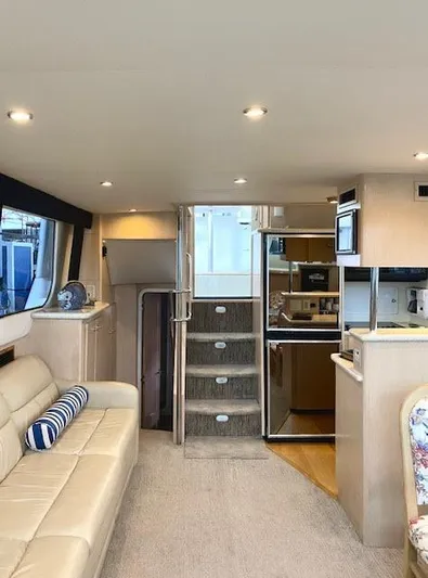  Yacht Photos Pics 1999 Carver 456 Aft Cabin Motor Yacht interior with beige seating and modern kitchen.