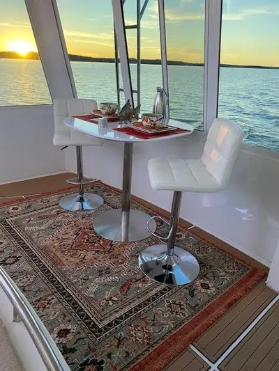  Yacht Photos Pics 1999 Carver 456 Aft Cabin Motor Yacht interior with elegant dining setup at sunset.