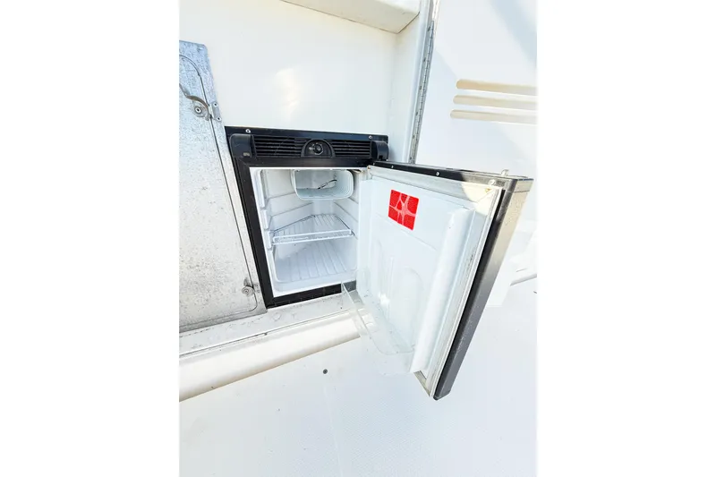 Steel Dreamin Yacht Photos Pics Open refrigerator on 2004 Silverton 48 Convertible yacht, showcasing interior storage space.