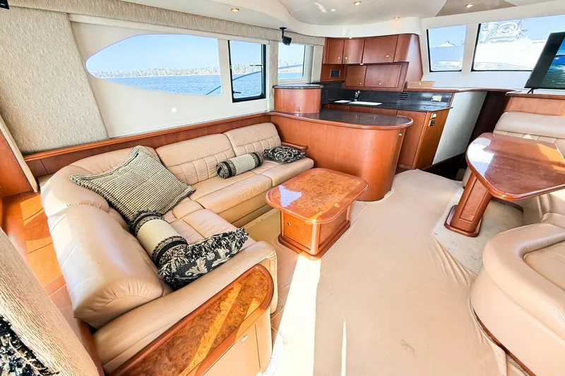 Steel Dreamin Yacht Photos Pics Luxurious interior of a 2004 Silverton 48 Convertible yacht with plush seating and elegant wood finishes.