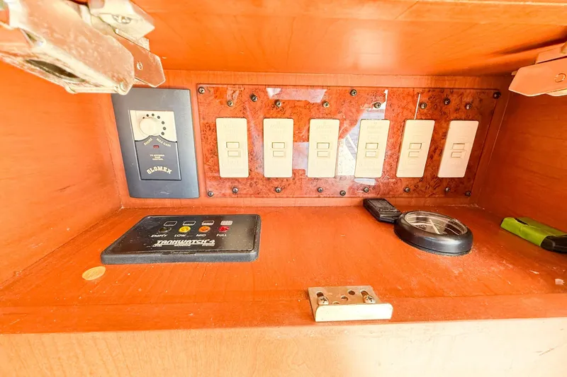 Steel Dreamin Yacht Photos Pics Control panel inside 2004 Silverton 48 Convertible yacht, featuring switches and electronic devices.