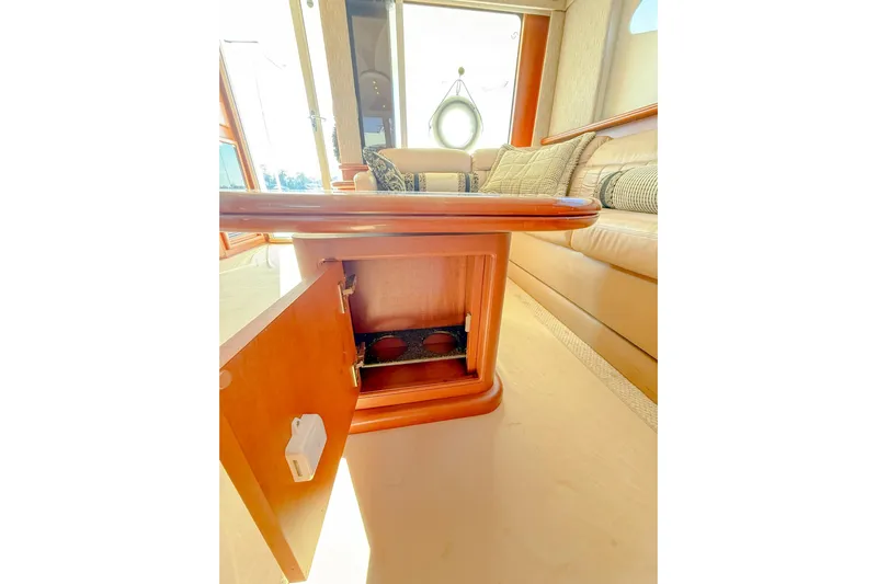 Steel Dreamin Yacht Photos Pics 2004 Silverton 48 Convertible yacht interior with open wooden cabinet and plush seating.