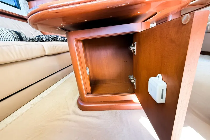 Steel Dreamin Yacht Photos Pics Open wooden cabinet inside 2004 Silverton 48 Convertible yacht interior.