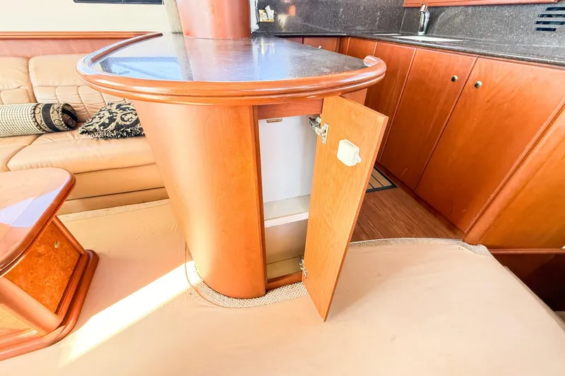 Steel Dreamin Yacht Photos Pics 2004 Silverton 48 Convertible yacht interior with open cabinet and luxurious seating.