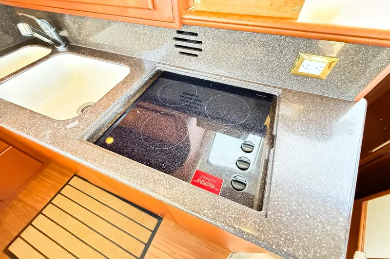 Steel Dreamin Yacht Photos Pics 2004 Silverton 48 Convertible kitchen with electric stove and sink.