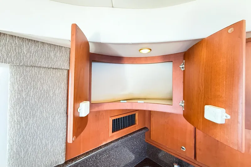 Steel Dreamin Yacht Photos Pics Open wooden cabinet in 2004 Silverton 48 Convertible yacht interior.