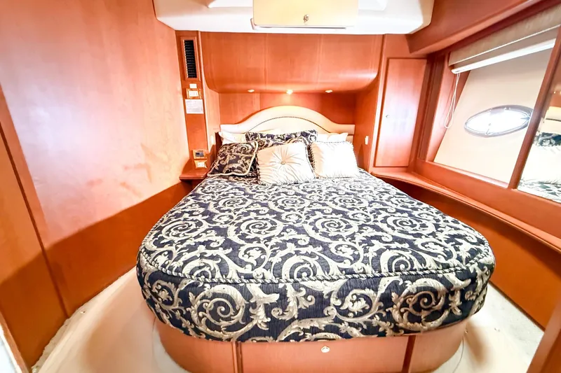 Steel Dreamin Yacht Photos Pics Luxurious bedroom interior of 2004 Silverton 48 Convertible yacht with elegant bedding.