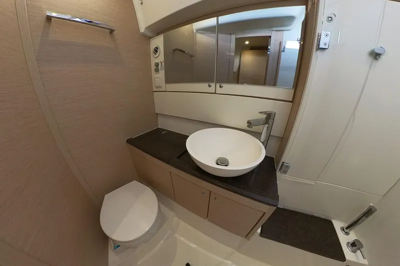  Yacht Photos Pics Modern bathroom in a 2020 Jeanneau 54 yacht with sleek fixtures and elegant design.
