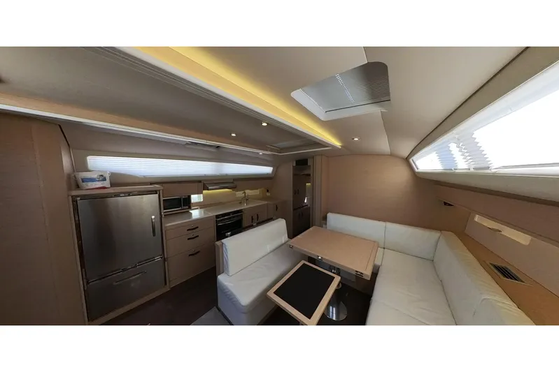  Yacht Photos Pics Luxurious interior of 2020 Jeanneau 54 yacht with modern kitchen and seating area.