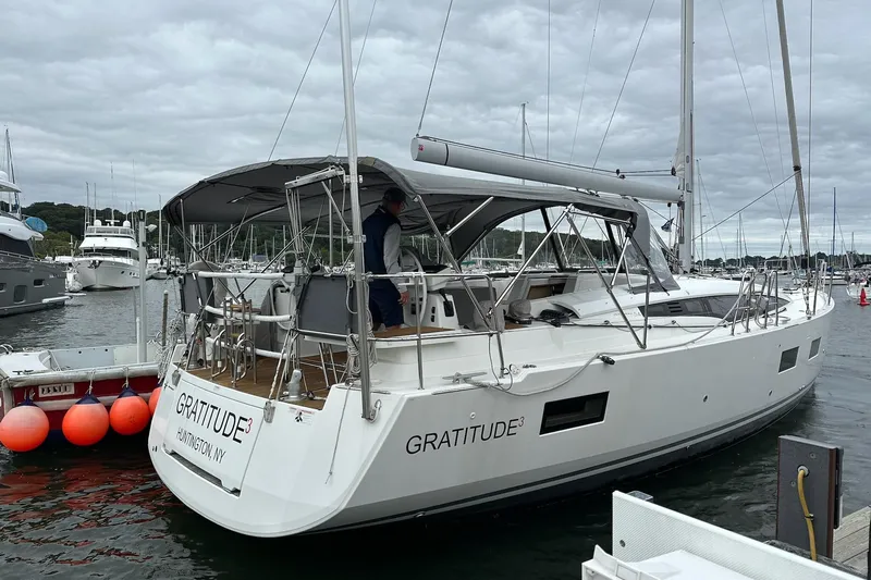 Yacht Photos Pics 2020 Jeanneau 54 sailboat named "Gratitude" docked at marina, overcast sky.