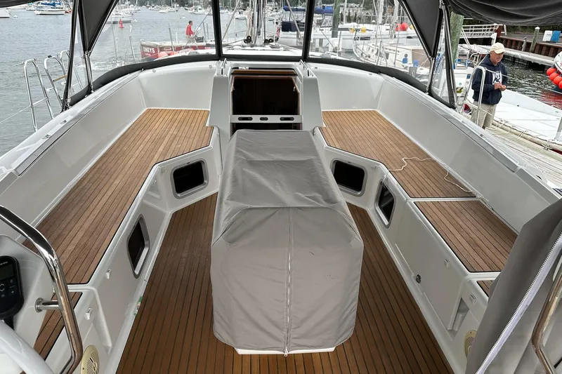  Yacht Photos Pics Spacious deck of a 2020 Jeanneau 54 yacht with wooden flooring and covered seating.