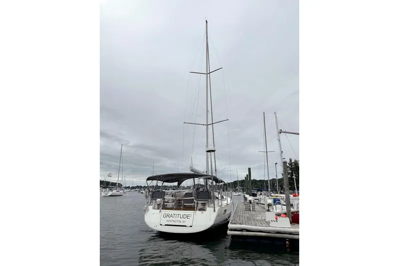  Yacht Photos Pics 2020 Jeanneau 54 sailboat docked at marina under cloudy sky.
