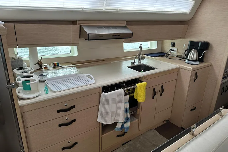  Yacht Photos Pics Modern kitchen interior of 2020 Jeanneau 54 yacht with appliances and storage.