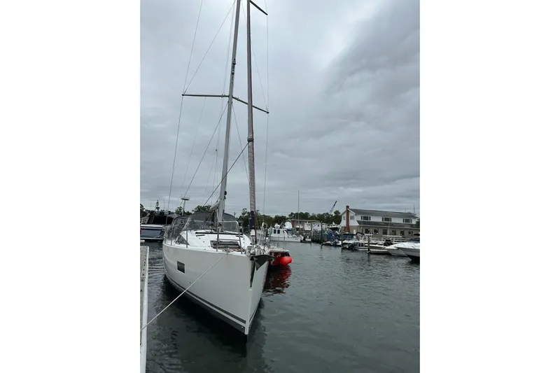  Yacht Photos Pics Sailboat Jeanneau 54, 2020 model, docked in a marina under cloudy skies.