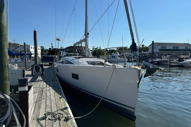 Yacht Photos Pics 2020 Jeanneau 54 yacht docked at marina under clear blue sky.