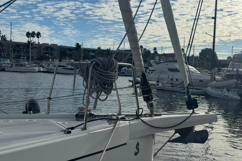  Yacht Photos Pics 2023 Beneteau Oceanis 46.1 sailboat docked in a marina under a partly cloudy sky.