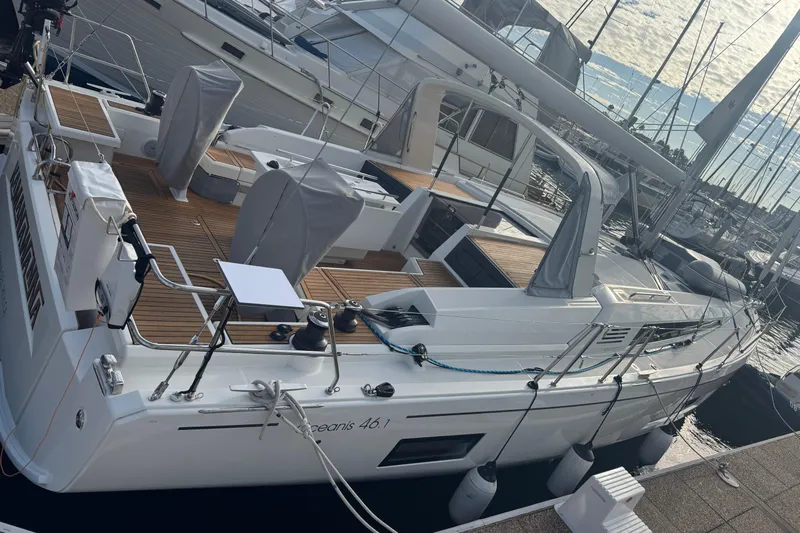  Yacht Photos Pics 2023 Beneteau Oceanis 46.1 yacht docked at marina, showcasing sleek design and spacious deck.