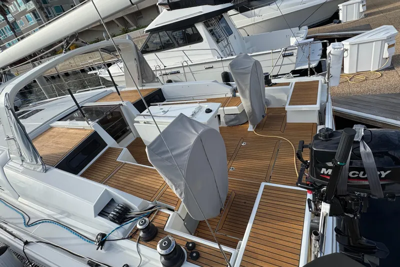  Yacht Photos Pics 2023 Beneteau Oceanis 46.1 yacht with teak deck and covered helm at marina.