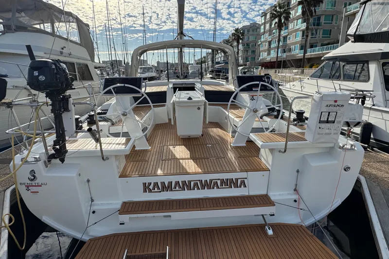  Yacht Photos Pics 2023 Beneteau Oceanis 46.1 yacht docked, featuring dual steering wheels and teak deck.